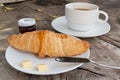 Croissant and coffee on wood table