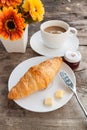 Croissant and coffee on wood table