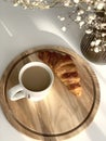 Croissant and cup of coffee with a saucer against the background Royalty Free Stock Photo