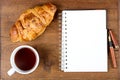 Croissant cup coffee white book pen on teak wood Royalty Free Stock Photo