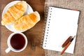 Croissant cup coffee white book pen Royalty Free Stock Photo