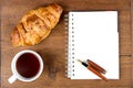 Croissant cup coffee white book pen on teak wood Royalty Free Stock Photo