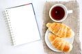 Croissant cup coffee white book table Royalty Free Stock Photo