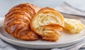 A croissant is cut in half and sits on a white plate Royalty Free Stock Photo