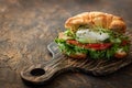 Croissant fish and poached egg sandwich