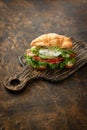 Croissant fish and poached egg sandwich