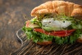 Croissant fish and poached egg sandwich