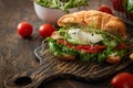 Croissant fish and poached egg sandwich