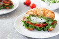 Croissant fish and poached egg sandwich