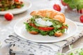 Croissant fish and poached egg sandwich