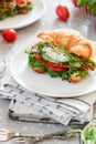 Croissant fish and poached egg sandwich