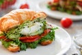 Croissant fish and poached egg sandwich