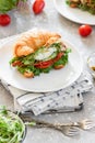 Croissant fish and poached egg sandwich