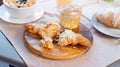 Croissant, honey jar and orange juice on wooden cutting board. Healthy breakfast Royalty Free Stock Photo