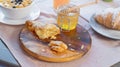 Croissant, honey jar and orange juice on wooden cutting board. Healthy breakfast Royalty Free Stock Photo