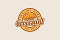 croissant logo with a combination of a croissant and beautiful lettering in emblem form