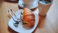 Croissant and meat on a girl's table at lunchtime. Royalty Free Stock Photo