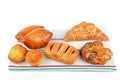 Croissant, muffin and other sweet pastries on rustic napkin isolated on white Royalty Free Stock Photo