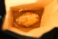 Croissant in a paper bag placed Vehicle Interio car