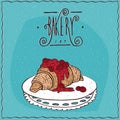 Croissant with red berries on lacy napkin