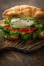 Croissant red fish and poached egg sandwich