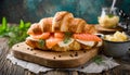 Croissant sandwich with cheese, salmon and dill on wooden board, table with ingredients, close up Royalty Free Stock Photo
