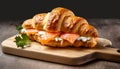 Croissant sandwich with cheese and salmon on wooden board, close up. Healthy breakfast concept Royalty Free Stock Photo