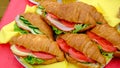 Croissant sandwich with cream cheese, tomatoes, cucumbers on beef, close-up. Healthy breakfast concept. Royalty Free Stock Photo