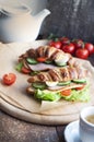 Croissant sandwich with ham, cheese, fresh salad and tomatoes Royalty Free Stock Photo