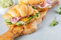 Croissant sandwich with ham, olives and vegetable Royalty Free Stock Photo