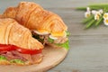 Croissant sandwiches on chopping board