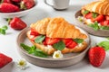 Croissant sandwiches with fresh ripe strawberries and cream cheese in a plate with cup of coffee for tasty breakfast Royalty Free Stock Photo