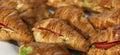 Croissant sandwiches on a plate. Appetizing starters. Close-up. Panorama format