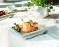 Croissant sandwiches on a table with teapot and cups at a wedding luncheon. Royalty Free Stock Photo