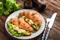 Croissant with scrambled egg, cheese and lettuce Royalty Free Stock Photo