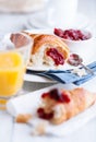 Croissant and sour cherry jam on white plates Royalty Free Stock Photo