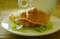 Croissant stuffed pork bologna and green oak with coffee cup