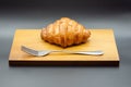 croissant on wooden cutting board with fork Royalty Free Stock Photo