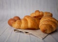Croissants with coffee cups with flour and eggs on a white background, breakfast, brown bread, morning drinks, fantasy world: Royalty Free Stock Photo