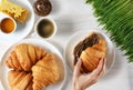 Croissants, coffee, honey, chocolate butter and sprouted wheat