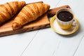 Croissants and coffee on a light background. The concept of delicious breakfast or lunch. At the bottom there is a place for copy Royalty Free Stock Photo