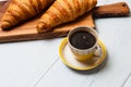 Croissants and coffee on a light background. The concept of delicious breakfast or lunch. At the bottom there is a place for copy Royalty Free Stock Photo