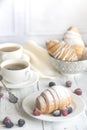 Croissants with fresh berries and two cups of coffee Royalty Free Stock Photo