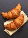 Croissants on grey slate background. Vertical image, top view