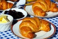 Croissants with jam and butter. Royalty Free Stock Photo
