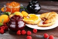 croissants with marmalade and assortment of jams, seasonal berries, apricot, mint and fruits Royalty Free Stock Photo