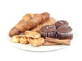 Croissants, muffins, cookies and stiks cinnamon of plate