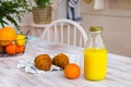 Croissants and orange juice in glass bottle on the wooden table. Royalty Free Stock Photo