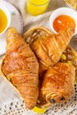 Croissants pastry for breakfast with tea and orange juice Royalty Free Stock Photo