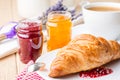 Croissants with raspberry and orange jam.